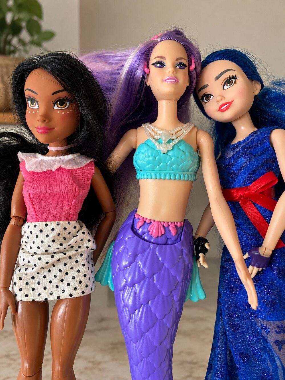 three dolls Barbie Dreamtopia Mermaid Doll with purple hair and purple-and blue